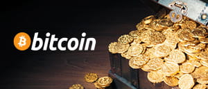 Dei gettoni d’oro e il logo della criptovaluta Bitcoin.